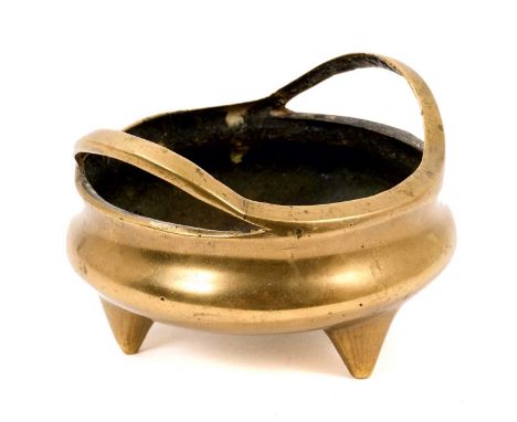 19th century Chinese bronze censer, with twin bi-furcated handles and sixteen character mark to the base on tripod supports, 