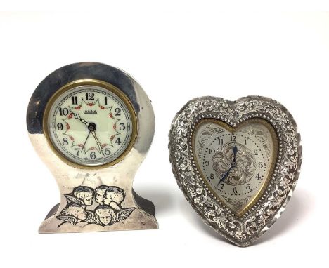 Victorian desk clock with heart shaped silver case, with embossed foliate decoration and strutt back (London 1888) C Macmicha