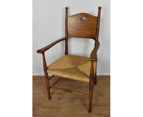 Arts &amp; crafts oak elbow chair with solid splat back and rush seat