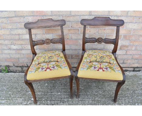 Pair of Regency mahogany dining chairs, each with carved bar back and slip in seat