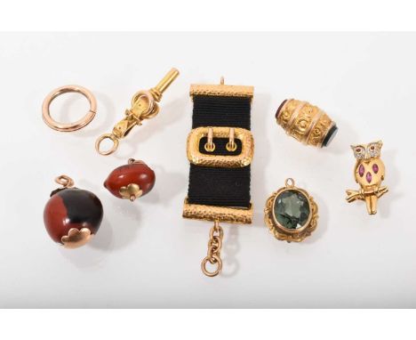 Group of antique charms to include Victorian gold/yellow metal watch key in the form of a belt buckle and rings, Victorian go