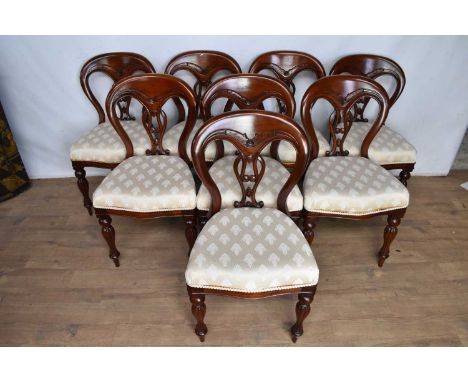 Set of eight Victorian style mahogany hoop back dining chairs, each with cream stuffover seat on fluted legs