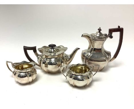 1920s three piece silver tea set, comprising teapot of fluted form, with hinged domed cover and ebony handle, matching sugar 