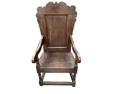 17th century oak wainscot chair, arched panelled back and carved arms, with solid seat on turned and block underframe