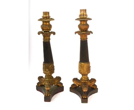 Pair of Regency bronze candlesticks, converted to lamp bases, each with patinated reeded column raised on tripod lions leg su