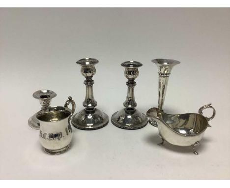 Pair of silver candlesticks, spill vase, sauce boat, christening mug and a dwarf candlestick