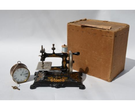 An early 20th century German sewing machine with floral gilt decoration in the Art Nouveau style (with instructions and box),