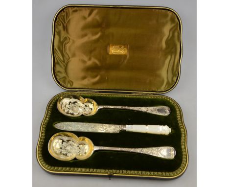 A late Victorian cased pair of silver and parcel gilt serving spoons with engraved decoration, to/w a matching knife with car