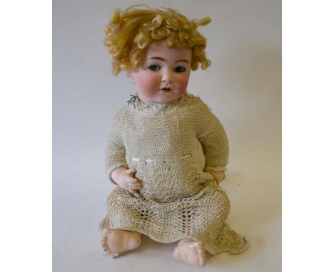 A German Franz Schmidt & Co., 1295 bisque-headed girl doll with curled blond wig, sleeping blue 'flirty' (swivelling) eyes an