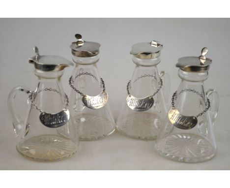 A set of four conical glass whiskey drams with silver collars and covers, Asprey & Co., Ltd., Birmingham 1930, each with a 'W