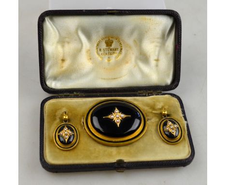 A Victorian mourning jewellery suite comprising an oval pendant brooch of black enamel with half pearl centre, with gold and 