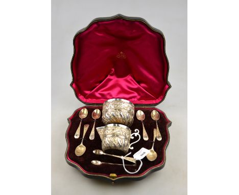 A late Victorian cased presentation set of silver and parcel gilt cream and sugar pair with embossed and chased decoration, t