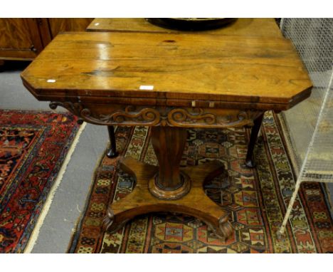 A Regency rosewood card table, the rectangular fold over top having canted corners, raised on a multi-faceted tulip form supp