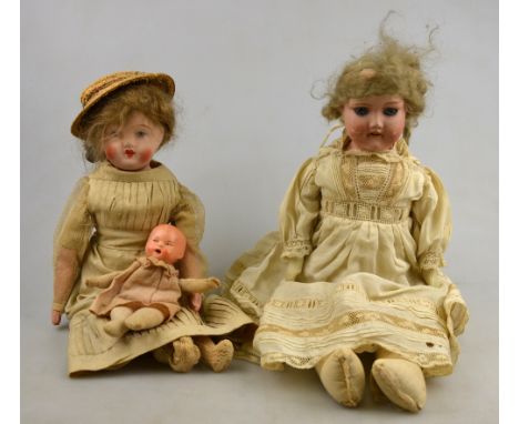 A small bisque-headed girl doll (not identified) with fixed blue eyes and open mouth, on stuffed cloth body, 34 cm, to/w anot