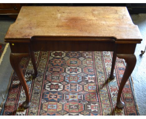 A George III mahogany card table, the shaped rectangular fold-over top over a frieze drawer to one end, raised on a gateleg a