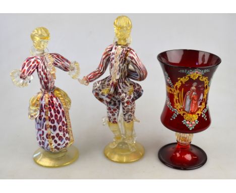 A pair of Venetian glass figures in 18th century style costumes, 22.4 cm h. to/w a Venetian ruby glass goblet with gold fleck