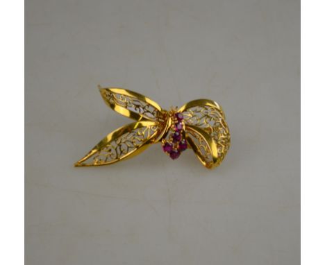 An 18ct yellow gold pierced stylised bow brooch set with rubies, 18ct yellow gold, Birmingham 1965, approx 10g all in to/w no