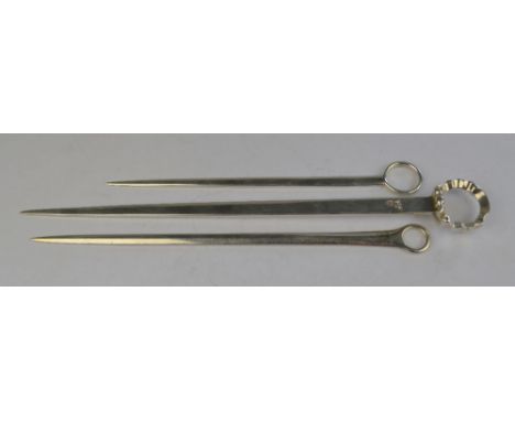 Three small Georgian silver meat skewers - one with decorative ring top, maker T.H., London 1774, two with plain rings, J.T. 
