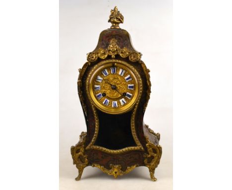A 19th century French Rococo Revival boulle mantle clock with gilt mounts and dial with enamel chapters, the Rollin drum move
