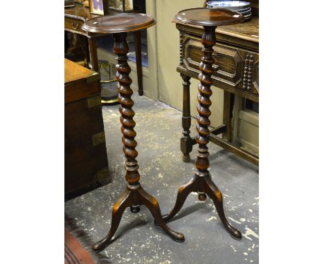 A pair of mahogany jardiniere stands, the dished circular platforms raised on barley twist supports to tripod bases, 106 cm h