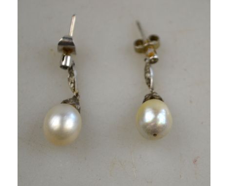 A pair of cultured pearl drop earrings suspended from small diamond studs, silver set Condition Report Replacement fittings a