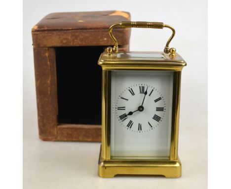 A French brass carriage timepiece with bevelled glass panels and enamel dial, in leather-bound travel-case (worn), 11 cm