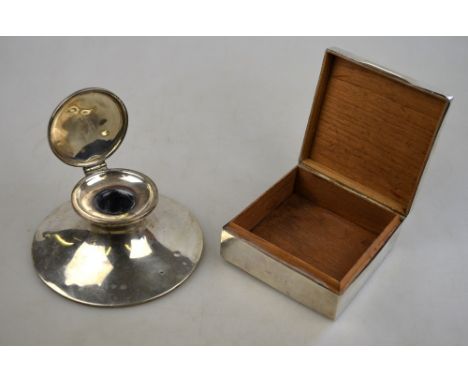 An Edwardian silver capstan inkwell, A & J Zimmerman, Birmingham 1908, to/w a cigarette box, Birmingham 1897 (2)