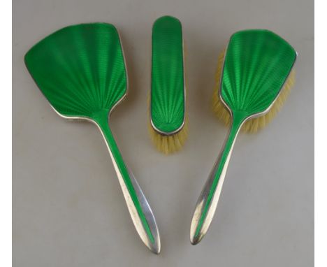 A silver and green basse-taille enamel three-piece brush set, Henry Clifford Davis, Birmingham 1934 Condition Report No damag