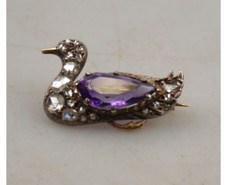 An antique amethyst and diamond set seated duck brooch with red stone eye, yellow gold and silver set Condition Report The di