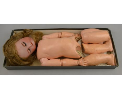 A Simon & Halbig/Kammer & Reinhardt 36 bisque-headed girl doll with blonde wig, closing blue eyes, pierced ears and open mout