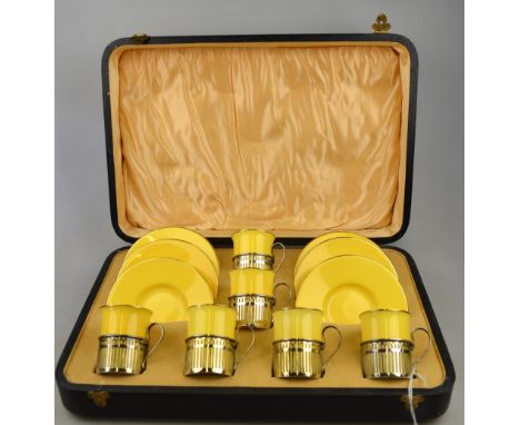 A Wedgwood coffee service, yellow ground with gilt borders, the cans having silver pierced holders, Walker & Hall, Sheffield 