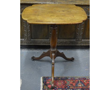 A Victorian mahogany tripod table, the shaped tilt top raised on a baluster turned support, 59 x 48 x 71 cm high