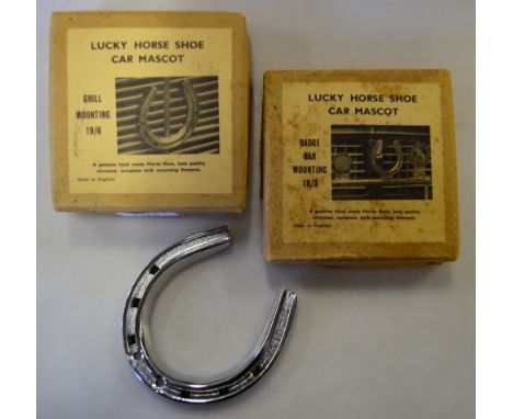 Three vintage grill-mounting 'Lucky Horse Shoe Car Mascots' (two boxed)