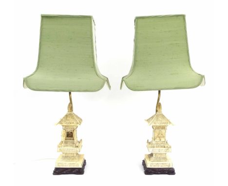 Pair of Chinese bone pagoda table lamps, the brass lamp uprights over carved and applied ivory pagodas with hinged doors encl