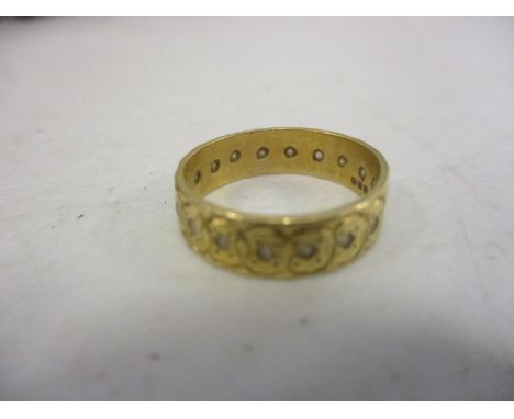 An 18ct gold ring set with paste stones 