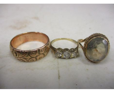 Three 9ct gold rings to include a three stone ring 