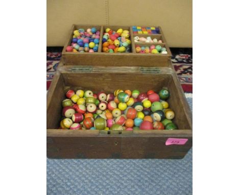 A hardwood box containing vintage wooden children's painted beads 