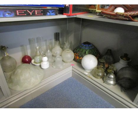 A quantity of oil lamp and table parts to include glass reservoirs and shades 