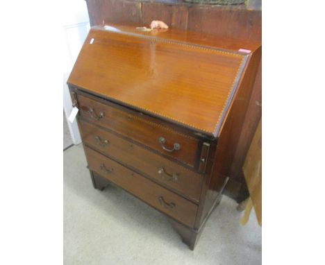 An Edwardian mahogany inlaid bureau having swan neck handles and bracket shaped feet 