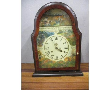 A modern walnut finished, cased mantle clock with an 8 day bell strike movement 