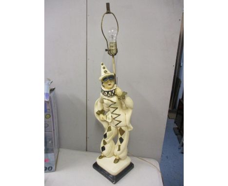 A vintage lamp in the form of a masquerade figure 