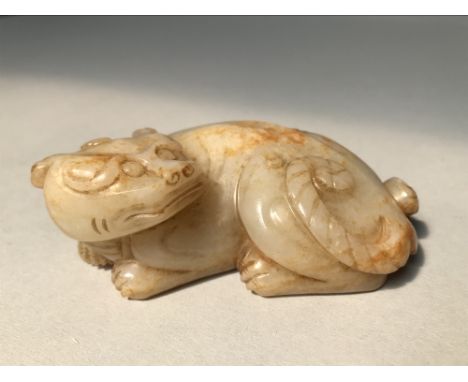 Chinese orange tinted jade carving of a mythical beast in recumbent pose 9cmL 