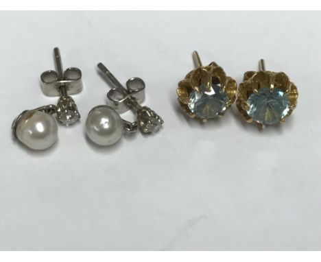 Pair of yellow metal and aquamarine stud earrings & a pair of pearl stud earrings with small diamond drops