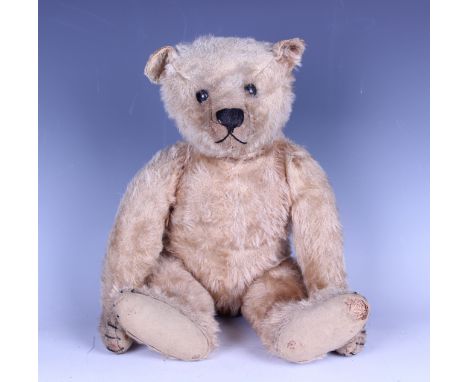 A wood straw-filled mohair humpback teddy bear with swivel head, probably Steiff (lacking button in left ear), with boot butt
