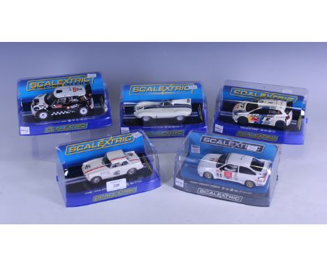 Five Scalextric rally and racing cars, comprising C3525 Volkswagen Polo R WRC, C3385 Mini Countryman WRC No. 12, C3308 Jaguar