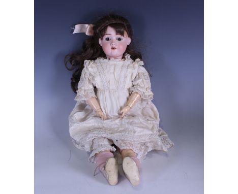 A Max Handwerck bisque head doll, impressed '01/4', with later brown wig, sleeping brown eyes, open mouth showing upper teeth