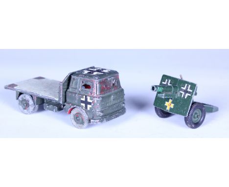 A collection of nine diecast military vehicles and accessories, including three Britains guns and a Dinky Toys No. 735 Gloste