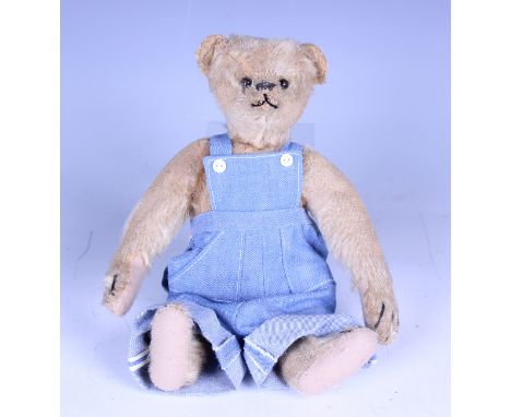 A mohair swivel-head humpback teddy bear, possibly Steiff, with boot button eyes, stitched snout and claws and jointed body w