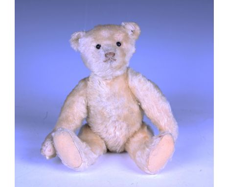 A Steiff blonde mohair humpback teddy bear with underscore button in left ear, boot button eyes, stitched snout and claws and