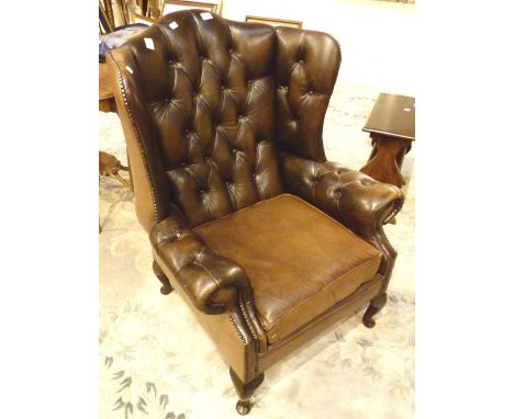 Brown leather button back armchair  CONDITION REPORT: Few age related cracks and use ware but no holes or deep scratches 